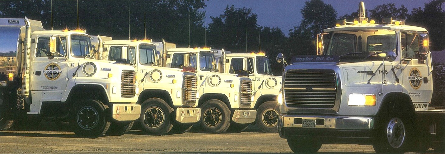 Taylor Oil Co. fleet lined up at dusk, 1990s